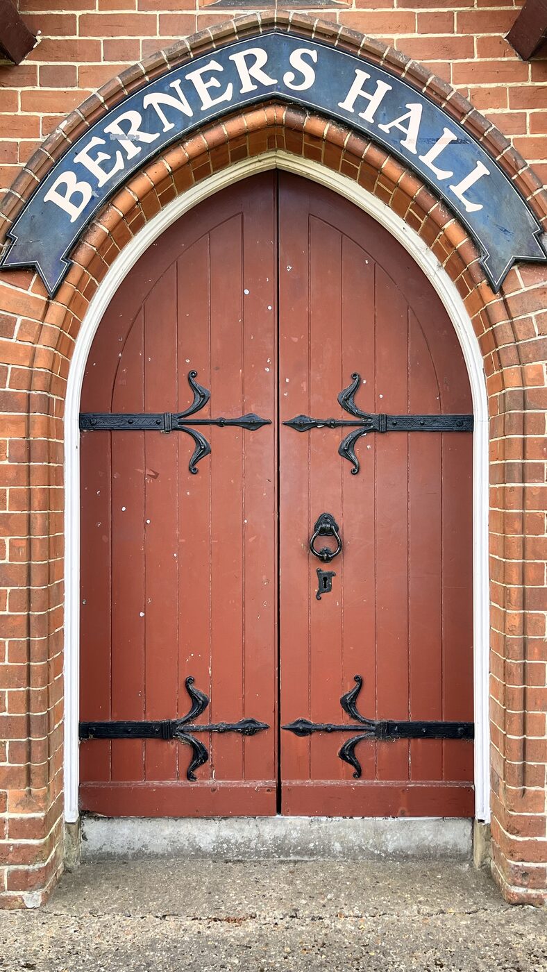 The red doors and Berners Hall sign above the entrance